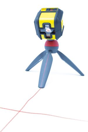 Laser level isolated on white background. This laser tool is useful for aligning objectsの写真素材