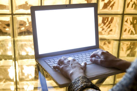 hands typing a letter in the keyboard of Stylish laptop computer with Isolated white screen. の写真素材