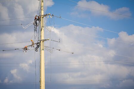 Workers repairing a high voltage industrial power energy line. Great for energy, safety and technology themes. : Almada, Portugal - September 29, 2008の写真素材