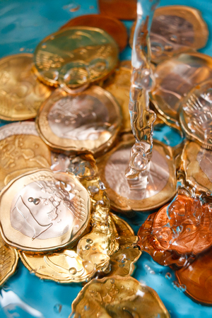 Water price concept with euro currency coins and water drops, vertical studio shotの写真素材