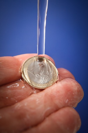 Water price concept with euro currency coins and water drops, vertical studio shotの写真素材