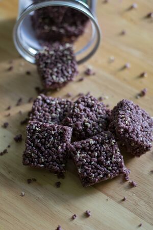 Crispy Riceberry Snack with white sesame seed on wooden.の写真素材