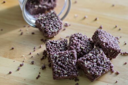 Crispy Riceberry Snack with white sesame seed on wooden.の写真素材