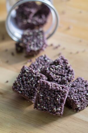 Crispy Riceberry Snack with white sesame seed on wooden.の写真素材