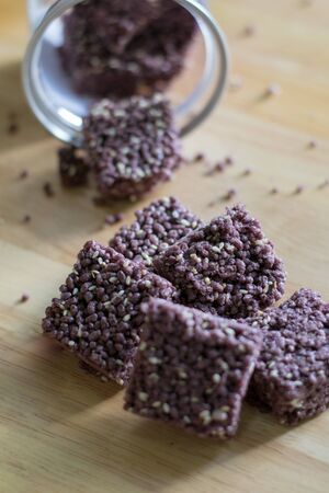 Crispy Riceberry Snack with white sesame seed on wooden.の写真素材