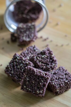 Crispy Riceberry Snack with white sesame seed on wooden.の写真素材