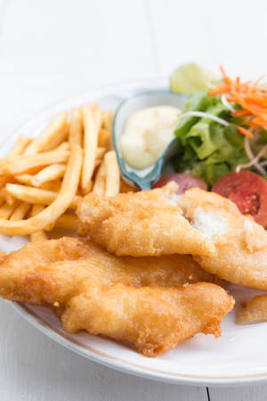 Fish and chips served with salad and sauceの写真素材