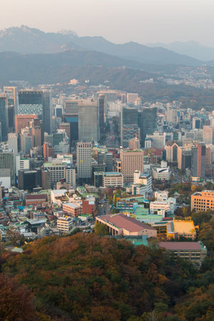many buildings with beautiful mountains in Seoul city in the evening