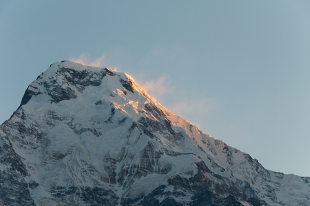 sunlight in the early morning is licking the snow mountain, feeling warmthの写真素材