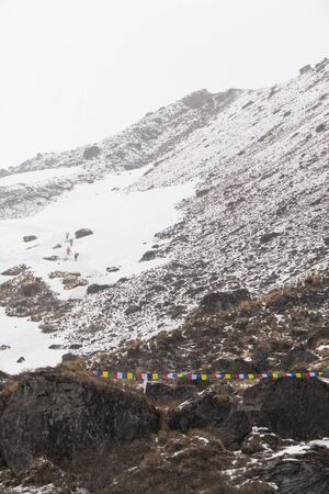 snow mountain hill with colorful flag in Nepalの写真素材