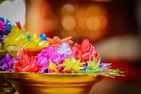 Artificial ribbin flowers on gold pedestal for decorationの写真素材