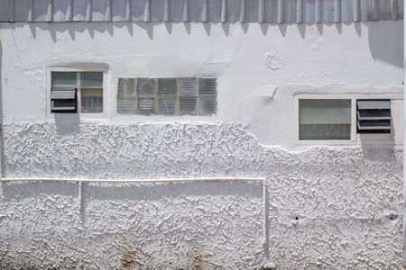 incomplete exterior white house with small window in suburbの写真素材