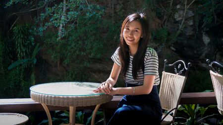 girl sit at restaurant in tropical natureの写真素材
