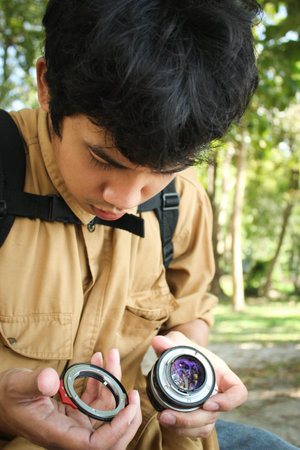 Photographer changes the camera lens in outdoorの写真素材