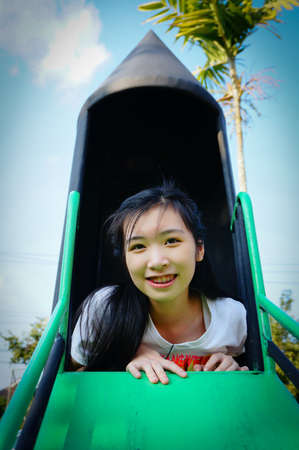 girl start to play slider playground in parkの写真素材