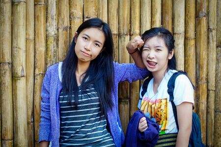 playful sister at bamboo sceneの写真素材