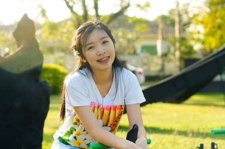 girl sitting on steel rocking horse at playgroundの写真素材
