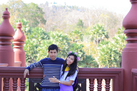 girl in official student uniform before wear the gown and her boyfriend take photo togetherの写真素材