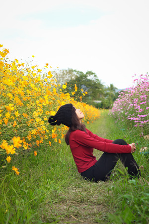 The Girl is happy to travel in colorful cosmos flower field at Muang Gan, Chiang mai city, Thailandの写真素材