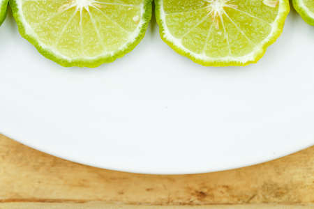 Top view of sliced bergamot on white dish with copy spaceの写真素材