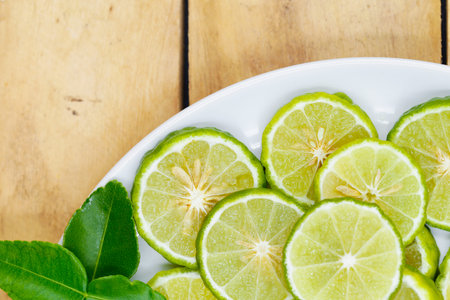 Top view of sliced bergamot on white dish  with copy space