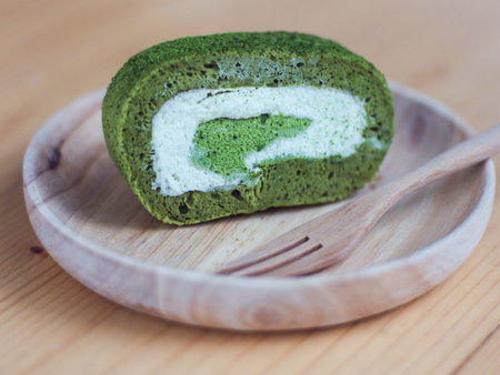 Green tea roll cake in bamboo plate 