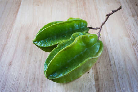 Carambola (Averrhoa carambola) on wood backgroundの写真素材