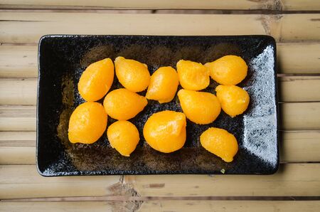 Gold drop sweets, thai dessert, egg yolk fudge balls cooked in syrupの写真素材
