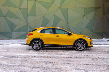 MOSCOW, RUSSIA - JANUARY 10, 2021 KIA XCeed. AWD Hatchback SUV. New KIA XCeed crossover model year 2020.Yellow KIA on winter background. Compact SUV car produced by Kia Motors. Front side close up viewのeditorial素材