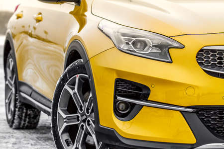 MOSCOW, RUSSIA - JANUARY 10, 2021 KIA XCeed. AWD Hatchback SUV. New KIA XCeed crossover model year 2020.Yellow KIA on winter background. Compact SUV car produced by Kia Motors. Front side close up viewのeditorial素材