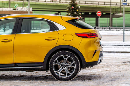 MOSCOW, RUSSIA - JANUARY 10, 2021 KIA XCeed. AWD Hatchback SUV. New KIA XCeed crossover model year 2020.Yellow KIA on winter background. Compact SUV car produced by Kia Motors. Front side close up viewのeditorial素材