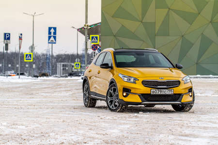 MOSCOW, RUSSIA - JANUARY 10, 2021 KIA XCeed. AWD Hatchback SUV. New KIA XCeed crossover model year 2020.Yellow KIA on winter background. Compact SUV car produced by Kia Motors. Front side close up viewのeditorial素材