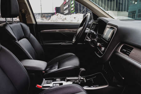 MOSCOW, RUSSIA - JANUARY 30, 2021 Mitsubishi Outlander dark interior close up view. Third generation of Japanese compact SUV. Mitsubishi Outlander model year 2020. Dashboard and steering wheel view.のeditorial素材