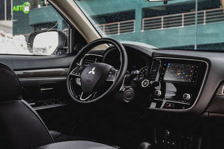 MOSCOW, RUSSIA - JANUARY 30, 2021 Mitsubishi Outlander dark interior close up view. Third generation of Japanese compact SUV. Mitsubishi Outlander model year 2020. Dashboard and steering wheel view.のeditorial素材