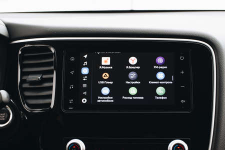 MOSCOW, RUSSIA - JANUARY 30, 2021 Mitsubishi Outlander dark interior view. Close up view of a car media dashboard screen with yandex auto software. Homescreen night theme.のeditorial素材
