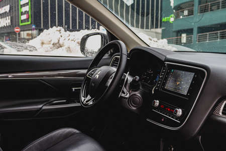 MOSCOW, RUSSIA - JANUARY 30, 2021 Mitsubishi Outlander dark interior close up view. Third generation of Japanese compact SUV. Mitsubishi Outlander model year 2020. Dashboard and steering wheel view.のeditorial素材