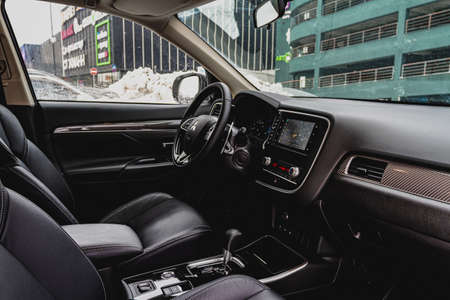 MOSCOW, RUSSIA - JANUARY 30, 2021 Mitsubishi Outlander dark interior close up view. Third generation of Japanese compact SUV. Mitsubishi Outlander model year 2020. Dashboard and steering wheel view.のeditorial素材