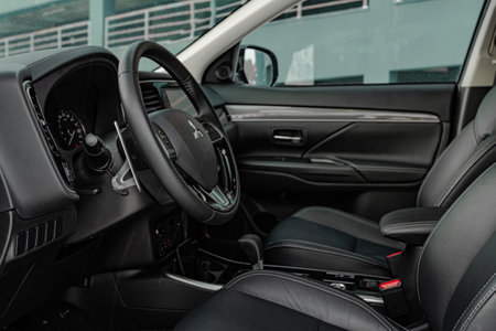MOSCOW, RUSSIA - JANUARY 30, 2021 Mitsubishi Outlander dark interior close up view. Third generation of Japanese compact SUV. Mitsubishi Outlander model year 2020. Dashboard and steering wheel view.のeditorial素材