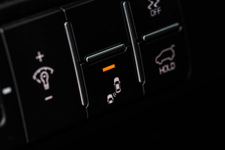 Modern car mirror blind spot detection toggle close up view. Vehicle interior detail of a modern...
