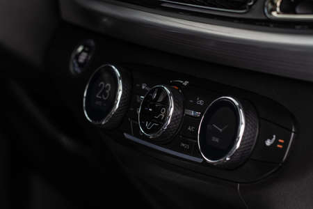 Digital control panel car air conditioner dashboard. Modern car interior conditioning buttons inside a car close up view.の写真素材
