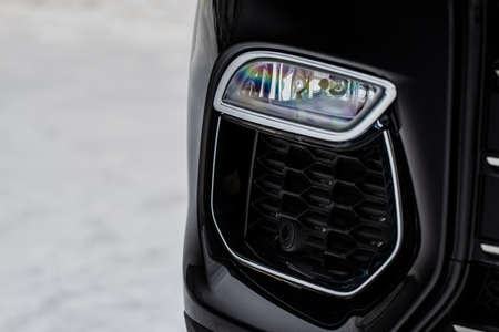 Close up fog light of the modern black car. Car front bumper with led headlight lightの写真素材