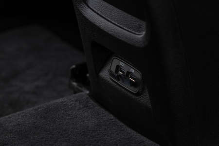 Opened car USB port in the car for connecting device. Power output of usb charger close up view. Car interior.の写真素材