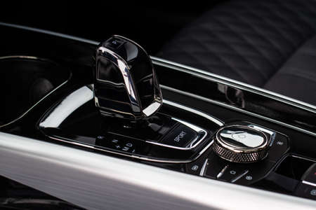 Close up of the automatic gearbox lever. Gear shift handle in a modern car. Modern car interior detail.の写真素材