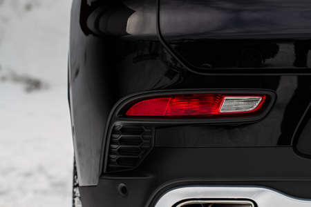 Close up back light of the modern black car. Rear car stop lights on car bumper.の写真素材
