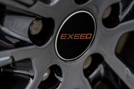 MOSCOW, RUSSIA - FEBRUARY 23, 2021 CHERYEXEED TXL SUV car front side view. Wheel close up view with exeed logo. Close up of rims.のeditorial素材