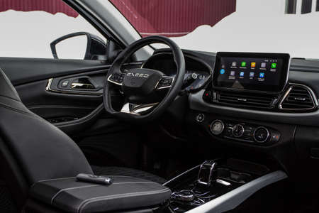 MOSCOW, RUSSIA - FEBRUARY 23, 2021 CHERYEXEED TXL SUV car dark interior close up view. Dashboard, driver seat and chery exeed logo on steering wheel close up view. Chery Exeed TXL / Vantas TXL.のeditorial素材