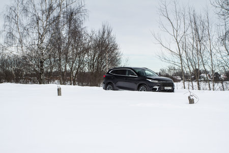MOSCOW, RUSSIA - FEBRUARY 23, 2021 CHERYEXEED TXL SUV car front side close up view. Black AWD SUV on...
