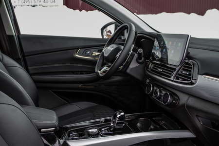 MOSCOW, RUSSIA - FEBRUARY 23, 2021 CHERYEXEED TXL SUV car dark interior close up view. Dashboard, driver seat and chery exeed logo on steering wheel close up view. Chery Exeed TXL / Vantas TXL.のeditorial素材