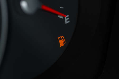 Empty fuel tank indicator close up view on modern car dashboard. Fuel indicator position empty.の写真素材