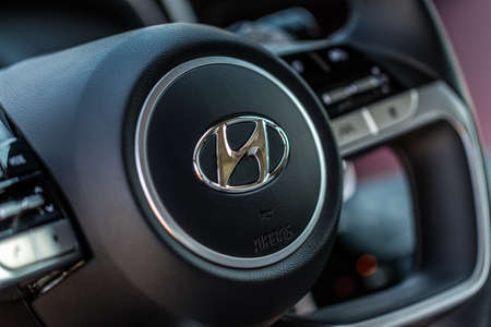 MOSCOW, RUSSIA - AUGUST 27, 2021 Hyundai Tucson Fourth generation NX4. Hyundai company logo on the steering wheel. Compact crossover SUV. Interior detail close up view.のeditorial素材